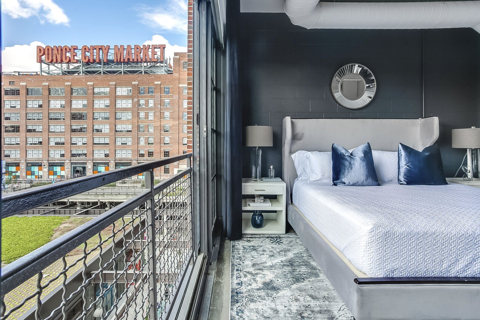 The large bed and nightstands of the Sleeping area of this Apartment Near Ponce City Market. The large bed and nightstands of the Sleeping area of this Apartment Near Ponce City Market.