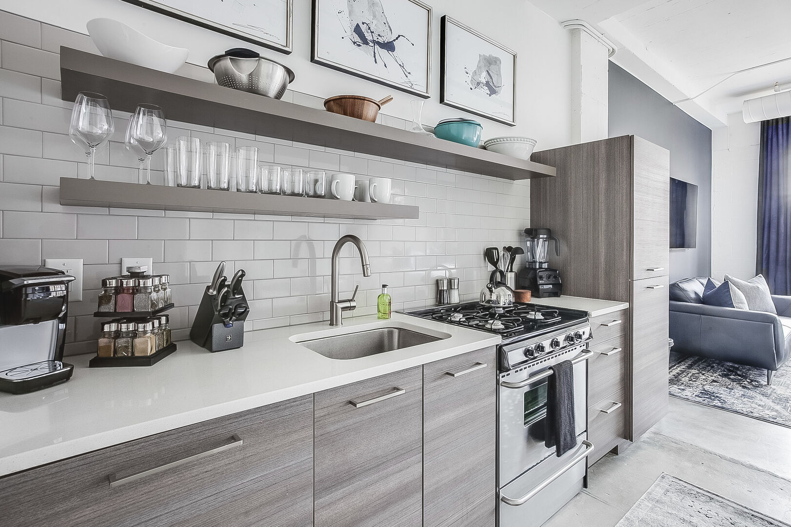 Kitchen with modern appliances and shelves full of bowls and cups. Kitchen with modern appliances and shelves full of bowls and cups.
