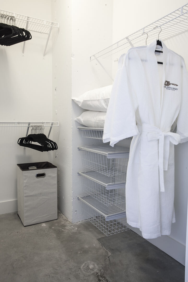 Closet with a robe hanging in it.