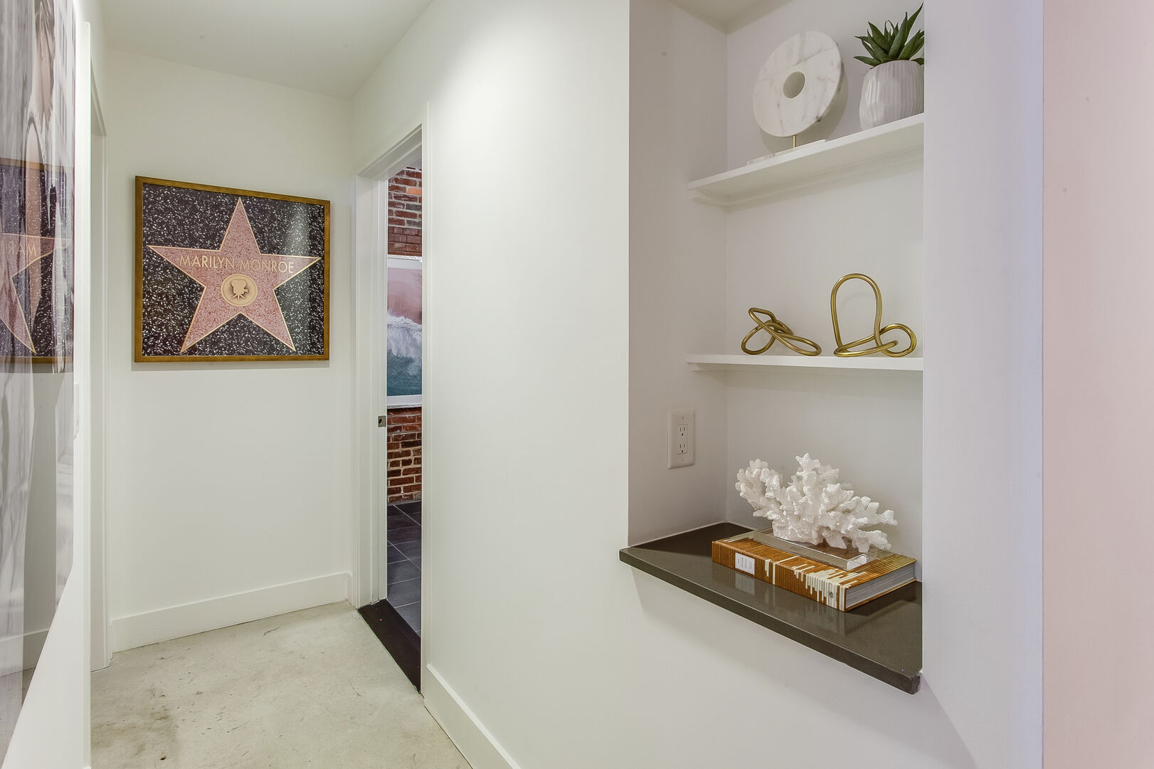 Hallway Includes Art and Space on Shelves.