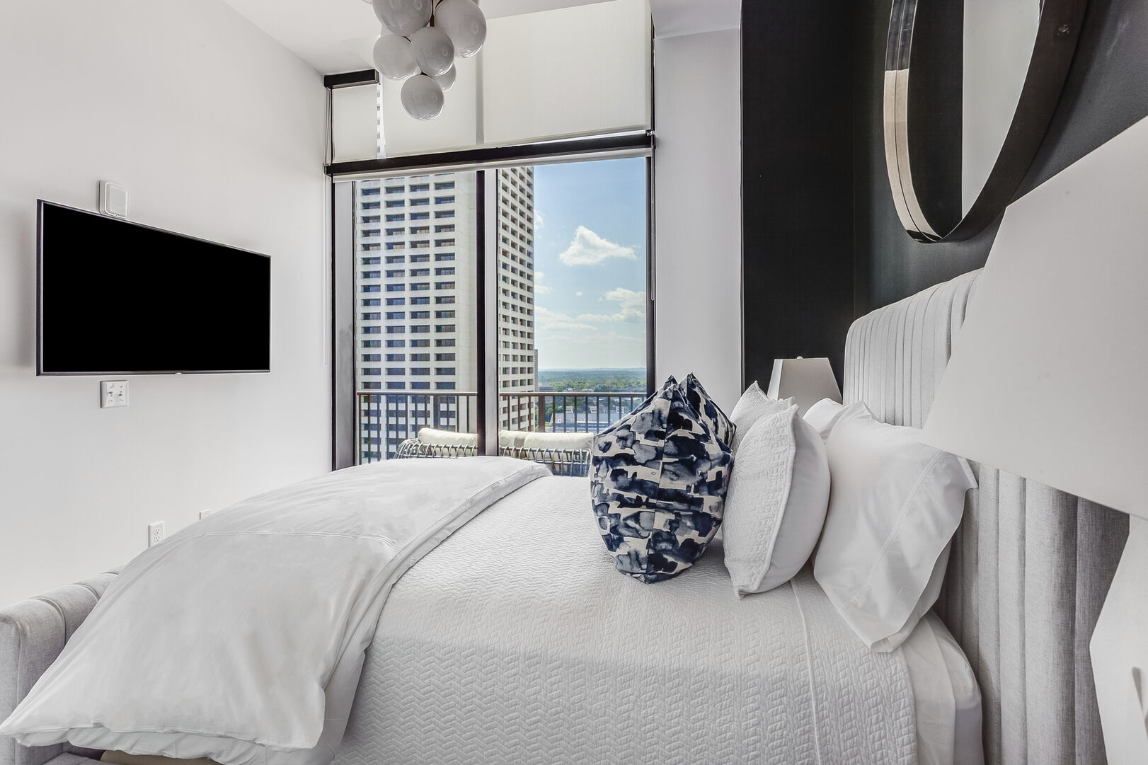 Image of Bed and TV Mounted on Wall in Guest Bedroom.