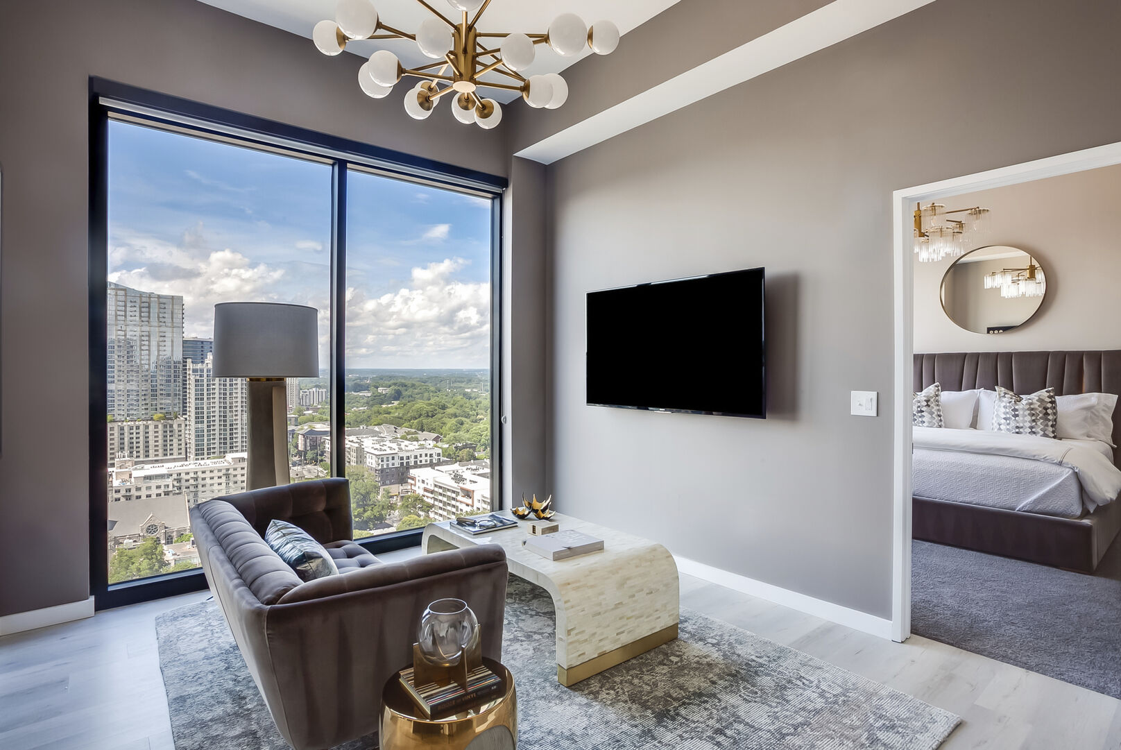 Living Area with Sofa, TV, and Large Window with City View