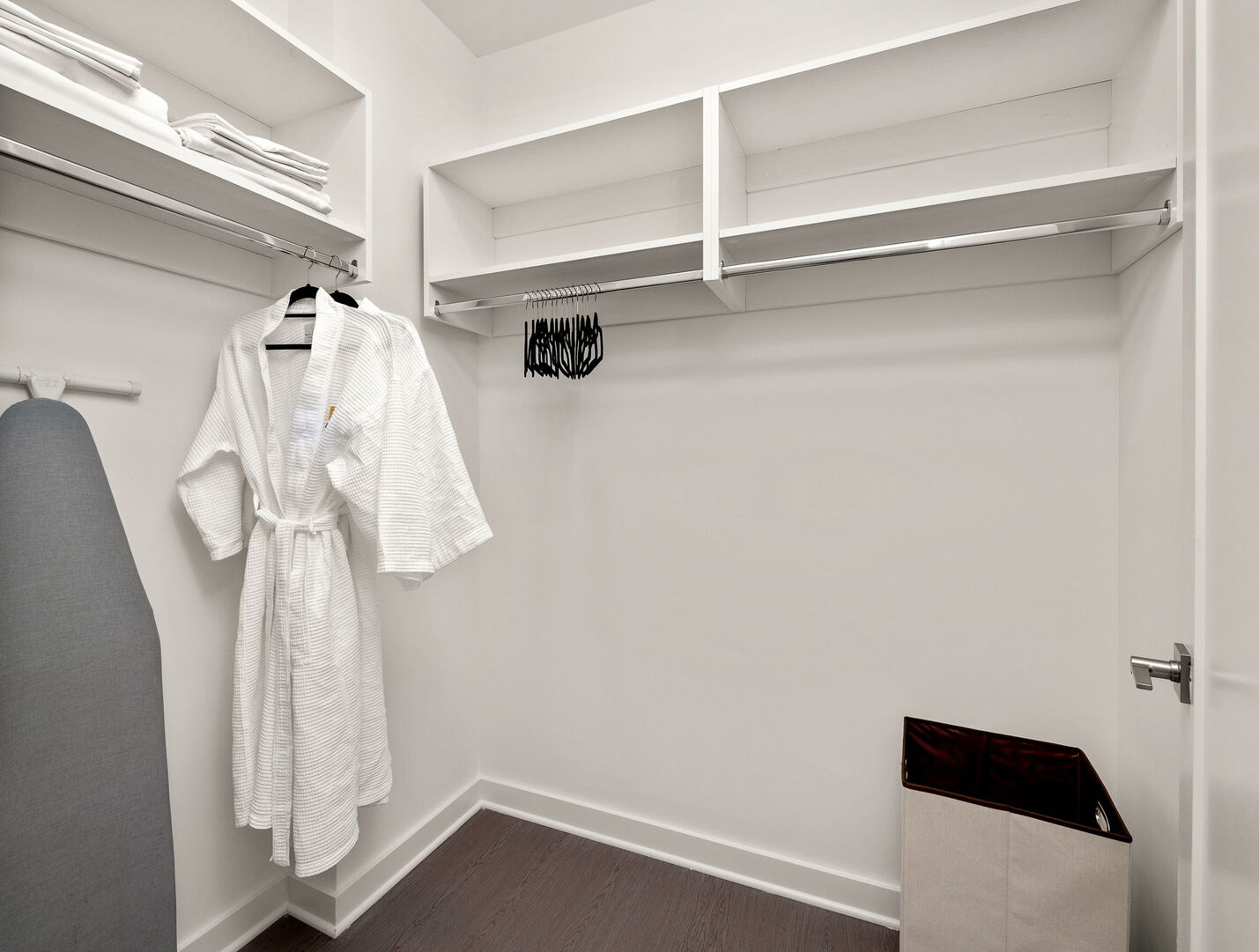 Spacious walk-in closet complete with an iron, ironing board, 50 hangers, and two Atlanta Luxury Rentals robes
