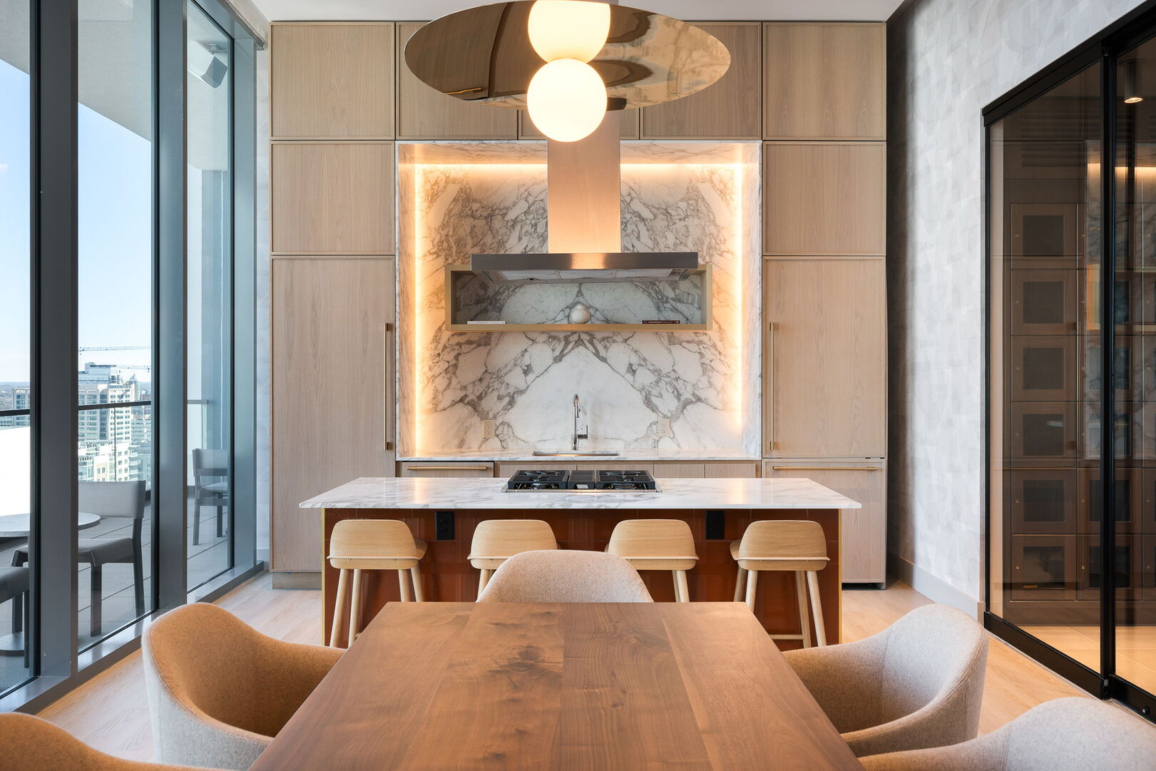 Private wine room featuring climate control for optimal storage, complete with seating and a fully equipped kitchen for hosting exclusive events