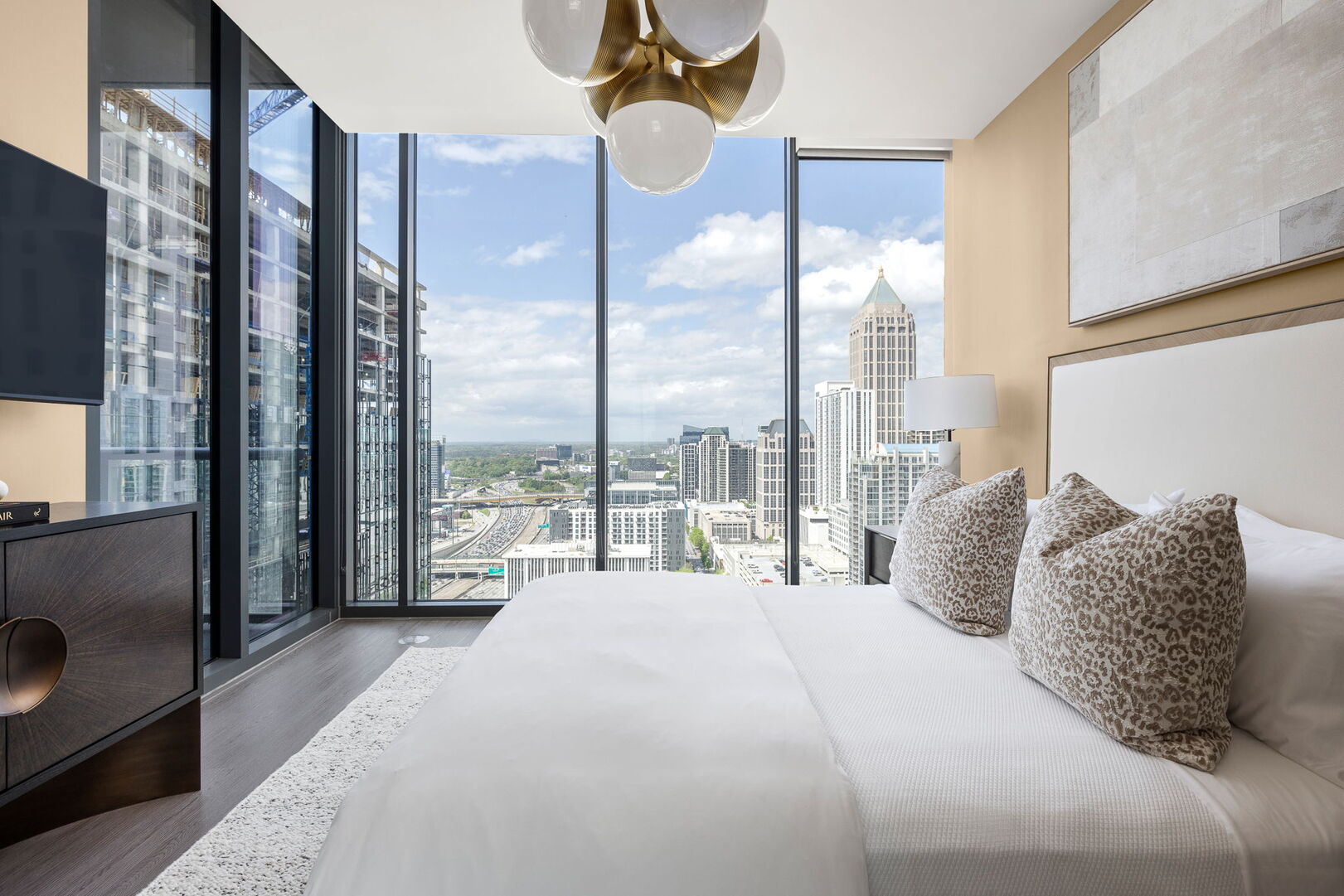 Primary suite with a queen bed and a 55 4K UHD TV