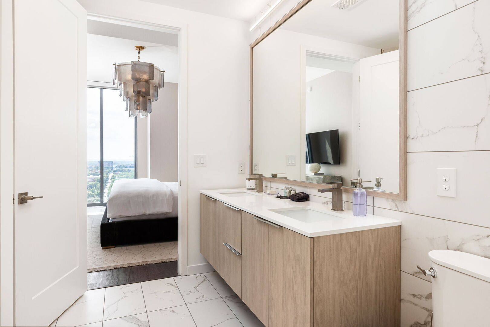 An en-suite bathroom featuring a double vanity and a spacious walk-in shower and closet An en-suite bathroom featuring a double vanity and a spacious walk-in shower and closet
