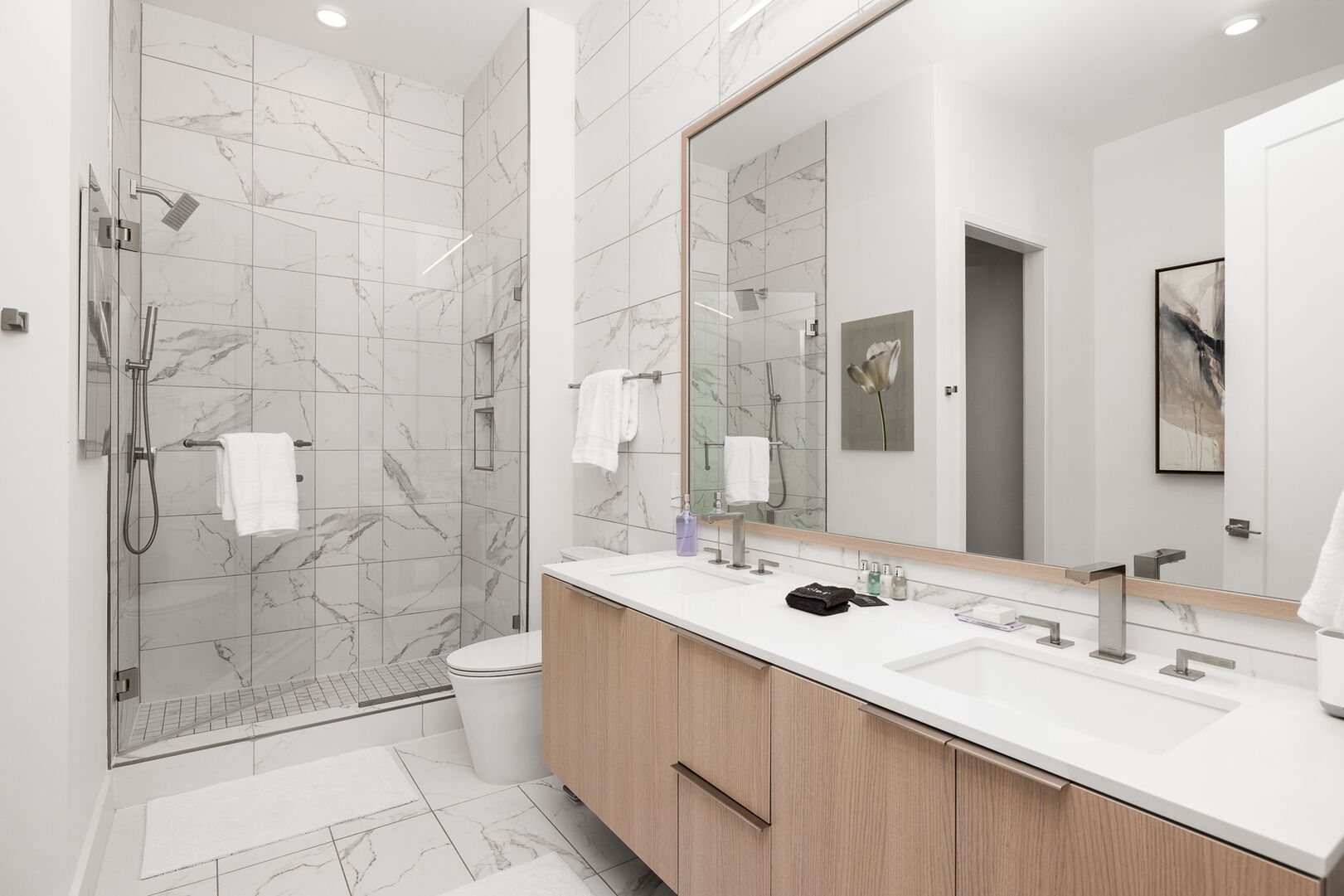 An en-suite bathroom featuring a double vanity and a spacious walk-in shower and a tub An en-suite bathroom featuring a double vanity and a spacious walk-in shower and a tub