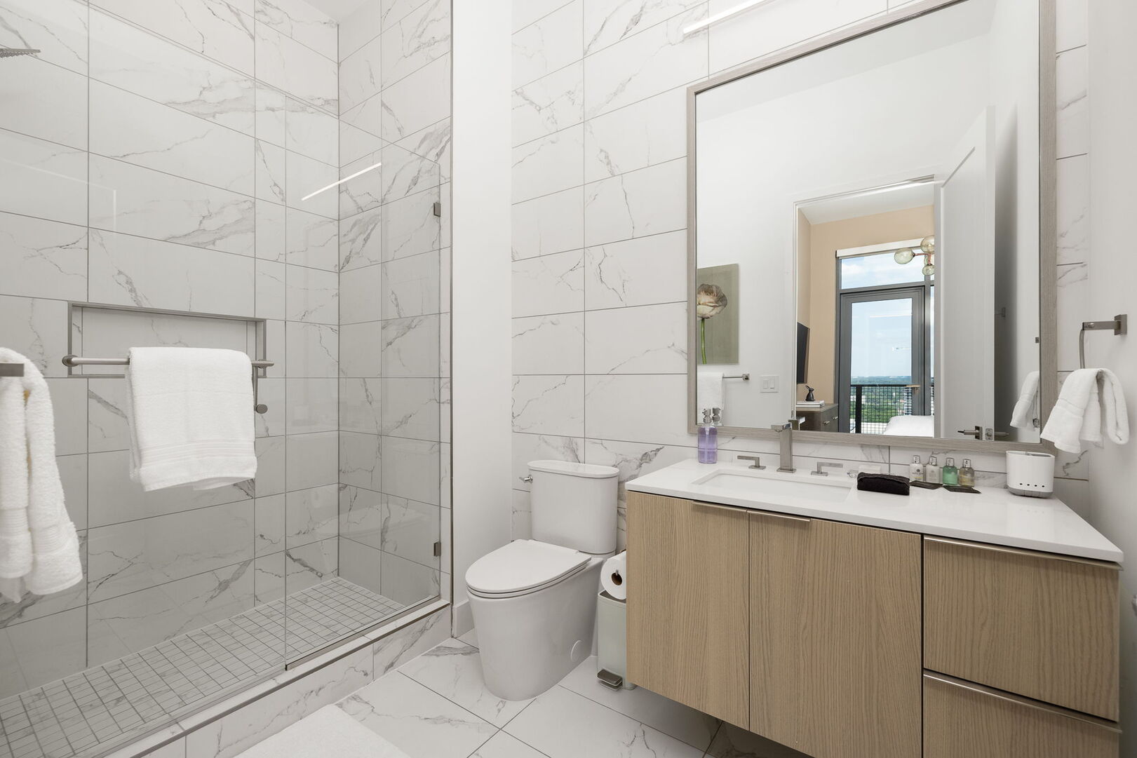 An en-suite bathroom featuring a a single vanity and a walk-in shower An en-suite bathroom featuring a a single vanity and a walk-in shower