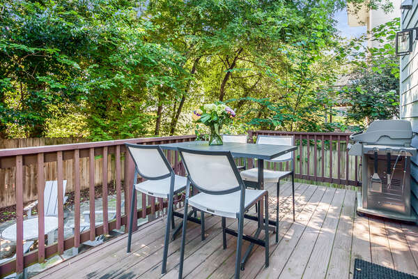 Outdoor Dining Table, Chairs, and BBQ Grill in the Backyard Deck.