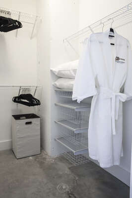 Closet with a robe hanging in it.