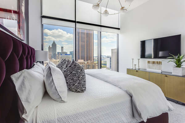 Image of Luxury Bed and TV Mounted on Wall.