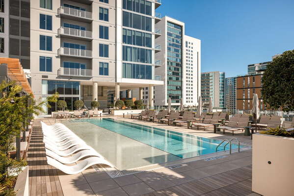 Luxury pool deck featuring private cabanas and pool loungers