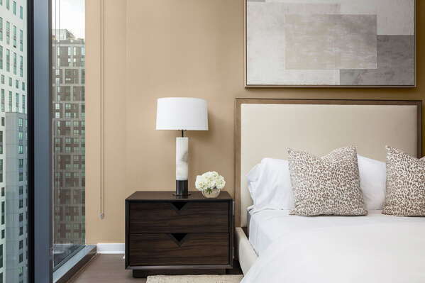 Primary suite with a queen bed and a 55 4K UHD TV