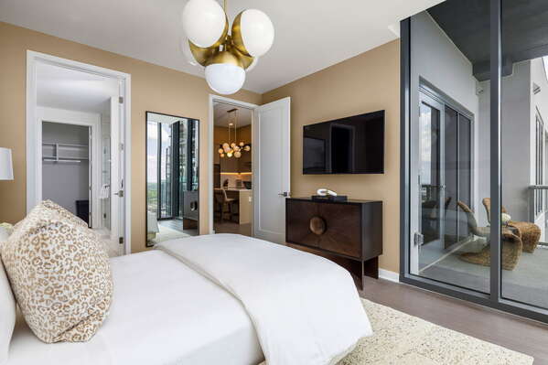 Primary suite with a queen bed and a 55 4K UHD TV