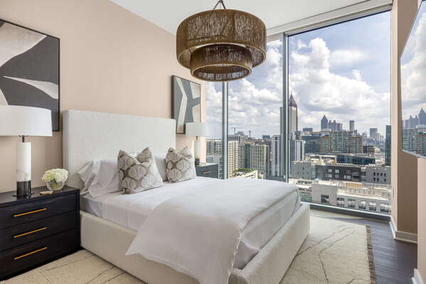 Secondary suite with a queen bed and a 55 4K UHD TV