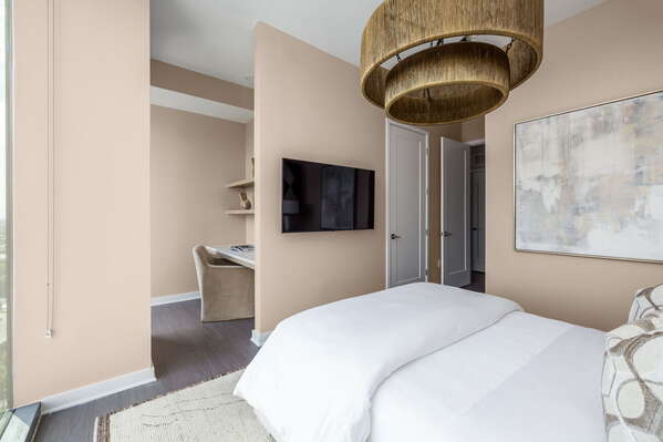 Secondary suite with a queen bed and a 55 4K UHD TV