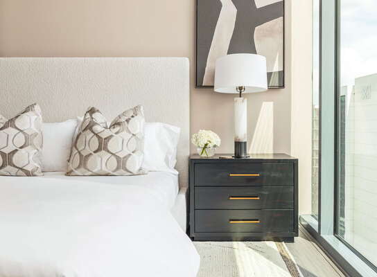 Secondary suite with a queen bed and a 55 4K UHD TV